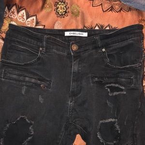 Embellish black ripped jeans with zippers